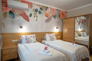 a hotel room with two beds and a mirror at SP Urban Apartment in Plovdiv