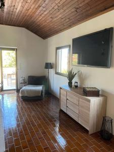 a living room with a large flat screen tv at Villa L.L in Splitska