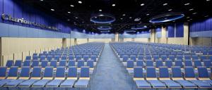 an empty auditorium with blue chairs in a building at Clarion Congress Hotel Olomouc in Olomouc +37 photos