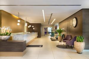 an office lobby with a reception desk and chairs at Crowne Plaza Düsseldorf - Neuss by IHG in Neuss