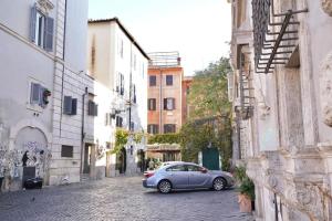 a car parked on a street in an alley at Trastevere Lovely Loft in Rome