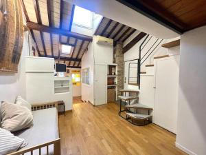 a large room with white walls and wooden floors at Trastevere Lovely Loft in Rome