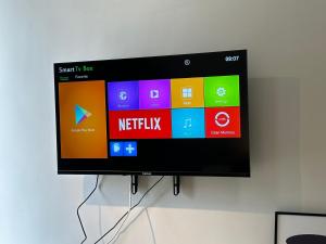 a flat screen tv hanging on a wall at Admiral 3-Bedroom Retreat in Kota Laksamana Jonker in Melaka