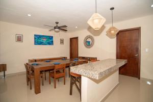a dining room with a table and a ceiling fan at Departamentos Sol, Mar y Arena in Isla Mujeres