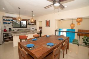 a kitchen and dining room with a wooden table and chairs at Departamentos Sol, Mar y Arena in Isla Mujeres +96 photos