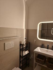 a bathroom with a sink and a mirror at Il nido di Luna in Turin +7 photos