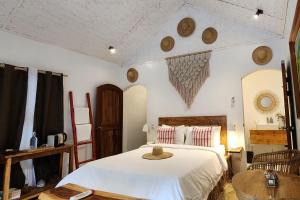 a bedroom with a bed with a hat on it at Sirom Beach House in Tambobong