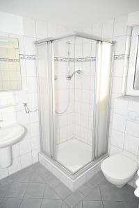 a bathroom with a shower and a toilet at Zweibettzimmer-03-EG in Borkum
