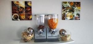 a table with two vases on a shelf with pictures at Zweibettzimmer-03-EG in Borkum