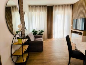 a living room with a couch and a mirror at Appartamento "Laghetto 2" in Castel San Pietro Terme