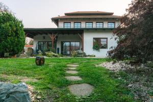 a house with a grass yard in front of it at Zen House u Poděbrad - Kanín in Poděbrady
