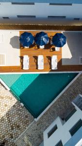 a view of a table with chairs and umbrellas at Condomínio Triângulo da Embaúba in Porto Seguro
