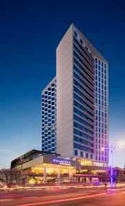 a tall building with a street in front of it at Starcity Hotel & Condotel Beachfront Nha Trang in Nha Trang