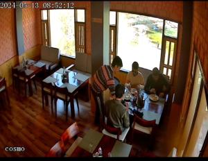 a group of people sitting at tables in a restaurant at Lakeside Nako Hotel & Restaurant in Nako
