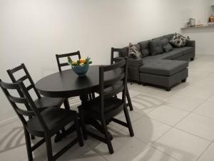a living room with a table and a couch at Deebing Hideaway - Harmony Haven in Loamside