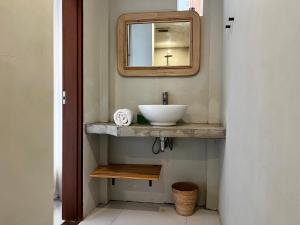 a bathroom with a sink and a mirror at Base Villa in Canggu