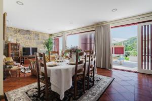 a dining room with a table with a white table cloth at Casa Zé Manel - Turismo Rural in Paranhos