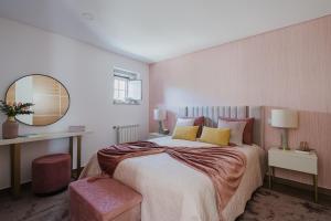 a bedroom with a large bed and a mirror at Casa Zé Manel - Turismo Rural in Paranhos +26 photos