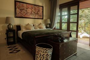 a bedroom with a large bed and a window at Pickleball Peak Villa Langkawi by Langit Hill in Ulu Melaka +15 photos