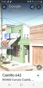 un póster de un edificio verde con un barco en él en Alojamiento castillo dpto 4, en Curuzú Cuatiá