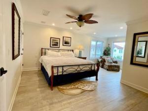 a bedroom with a bed and a ceiling fan at Moonlight Sonata-Beachfront-Community Pool in St. George Island