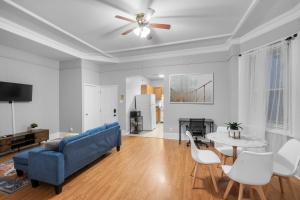 a living room with a blue couch and a table at Charming 2br Near Drexel in Philadelphia