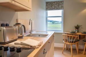 a kitchen with a sink and a counter top at Monsal Trail Apartment A, Bakewell in Hassop +26 photos