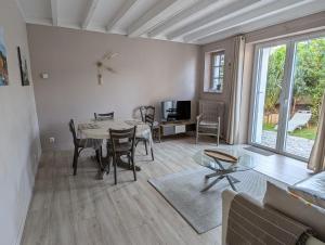 a living room with a table and chairs at Maison typique, centre-ville, jardin ville haute in Pornic