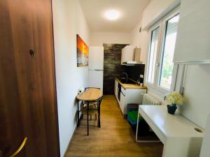 a small kitchen with a table and a small table at Appartamento "Laghetto 2" in Castel San Pietro Terme