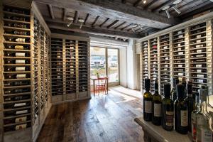 a wine cellar with a bunch of wine bottles at Drogheria e Locanda Franci in Montalcino