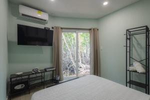 a bedroom with a bed and a large window at Fragata Island House in Isla Grande