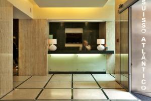 a lobby with a mirror and a person in the reflection at TURIM Restauradores Hotel in Lisbon