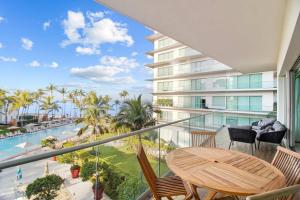 a balcony with a table and chairs and a view of the ocean at Spectacular Apartment Ocean View Puerto Vallarta in Puerto Vallarta