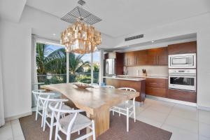a kitchen with a wooden table and chairs and a chandelier at Spectacular Apartment Ocean View Puerto Vallarta in Puerto Vallarta