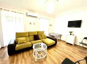 a living room with a couch and a flat screen tv at Casa con Encanto in Santa Amalia