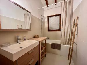 a bathroom with a sink and a shower and a tub at Chalet Mao in Megève