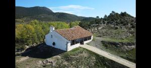 an aerial view of a small white building on a hill at Casa la Cisterna in Pina de Montolgrao