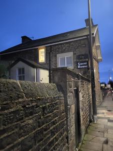 an old stone building with a brick wall at Station Guesthouse - Self entry via keypad inc parking in Lancaster +22 photos
