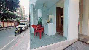 two red chairs sitting in a window of a building at Luxurious apartment at Dhaka in Dhaka