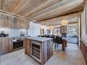 a kitchen and dining room with wooden ceilings and a table at Appartement Familial Confort à Val-d'Isère, Proche Pistes, 10 Pers., Cheminée, Services Inclus - FR-1-567-106 in Val dʼIsère