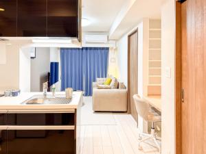 a kitchen with a sink and a couch in a room at Triphome Tokyo Sugamo 2024 New 3 mins 2 stations in Tokyo