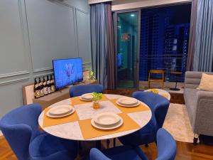 a dining room with a table and blue chairs at Bloomsvale Residence in Kuala Lumpur