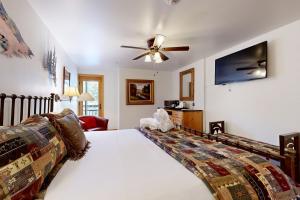 a bedroom with a bed and a ceiling fan at Lion Square Lodge East 310 in Vail +93 photos