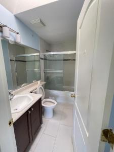 a bathroom with a toilet and a sink and a shower at Cozy Guest Rooms Near UBC, Downtown and Beaches in Vancouver +12 photos