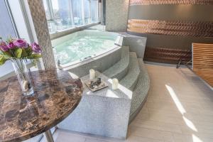 a jacuzzi tub in a room with a table at Sonesta Hotel Arequipa in Arequipa +114 photos