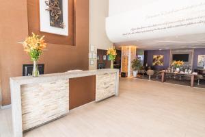 a lobby with a reception desk with flowers on it at Sonesta Hotel Arequipa in Arequipa