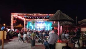 a crowd of people sitting at tables in front of a stage at MOBIL HOME n 2 TOUT CONFORT ST CYPRIEN 66 in Saint-Cyprien +26 photos