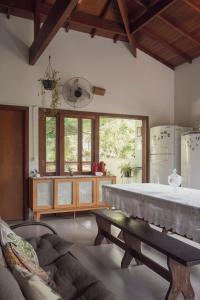 a living room with a large bed and a couch at Casa Viva Itamambuca in Ubatuba