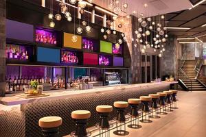 a bar with a row of stools in a restaurant at Exclusive Condo w Beautiful City Views and Full Amenities! in Miami