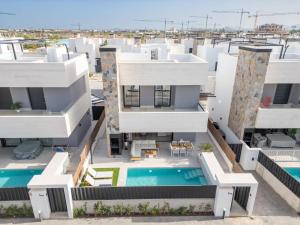 an aerial view of a building with a swimming pool at Villa Almendro Santa Rosalia Lake and Life Resort by PREMIUM SPAIN PROPERTIES in Torre-Pacheco